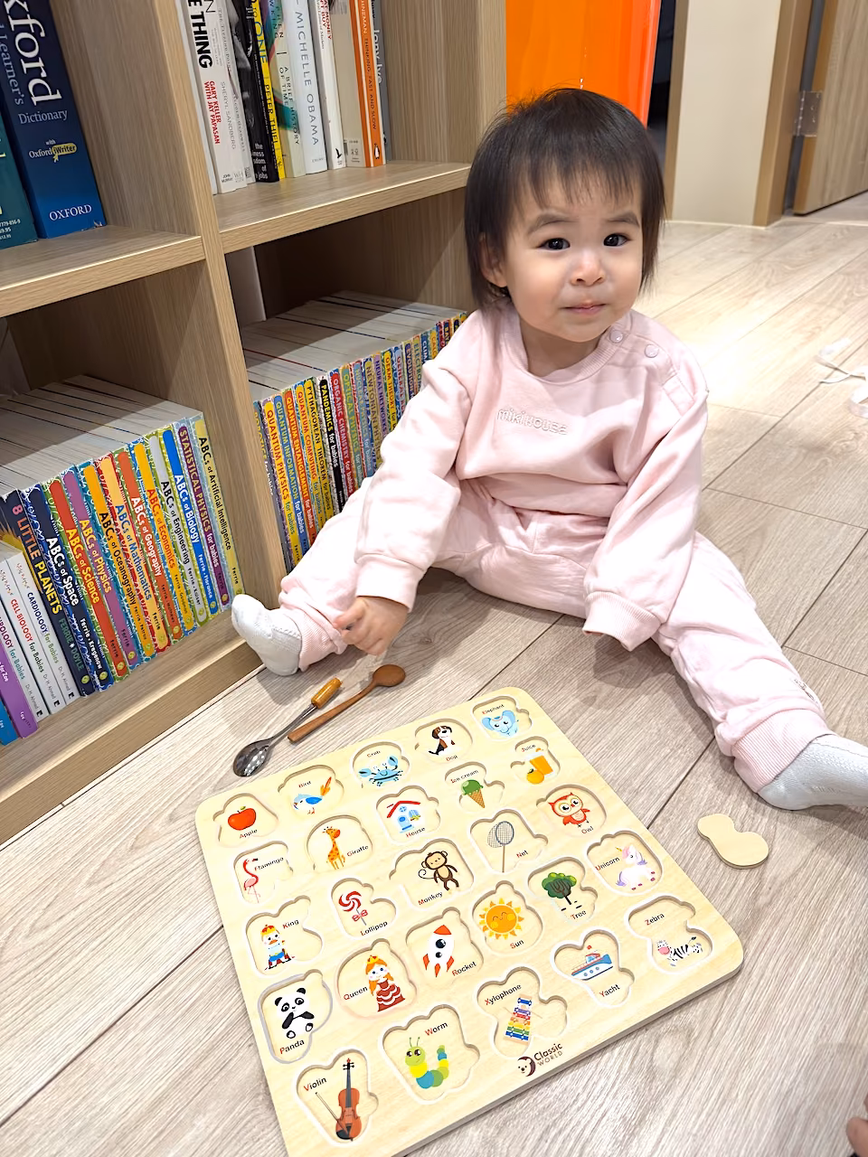 Puzzle time by the bookshelf — play and learning, side by side.