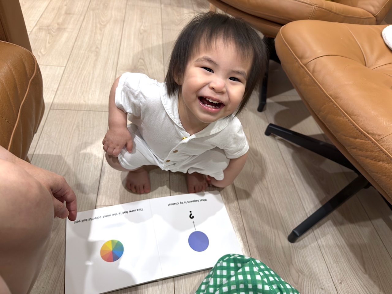 A big smile for a big idea — enjoying learning time on the floor.